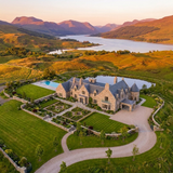 Aerial view of luxury Scottish estate with gardens and loch